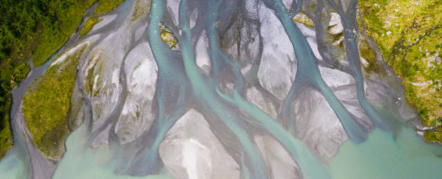 Branching streams from the Boyabreen Glacier in Norway meet the sea.