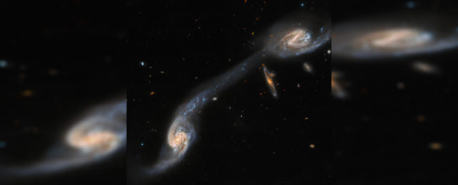 Galactic triplet 248, with two large spiral galaxies connected by a tidal tail.