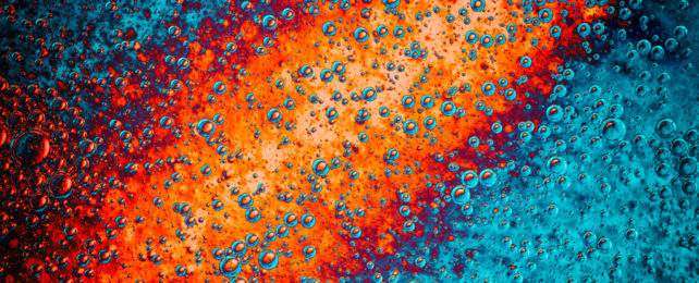 An illustration of a bright orange volcanic eruption underwater.
