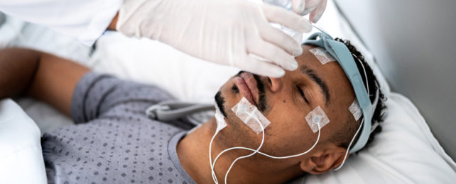 A person has electrodes attached to their head.