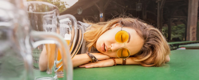 A sleeping hungover woman at a beer graden.