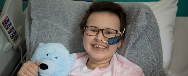 Smiling Girl Patient In Hospital Bed