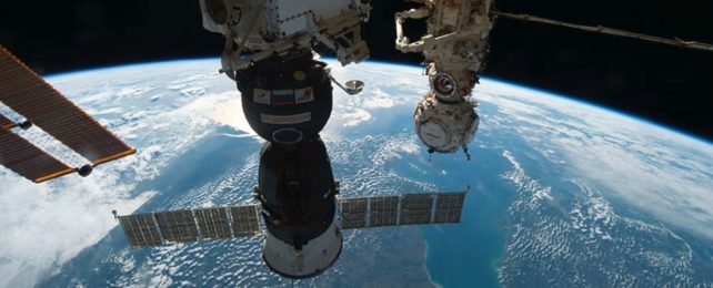 The Soyuz MS-22 crew ship docked to the Rassvet module, with Earth in the background