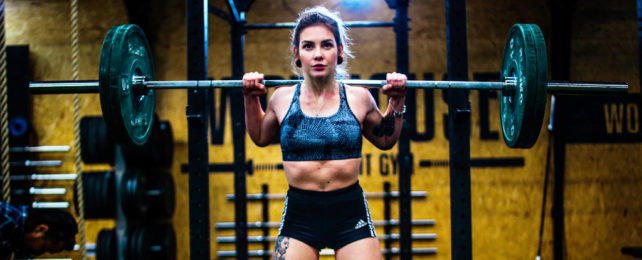 Woman lifting heavy weights.