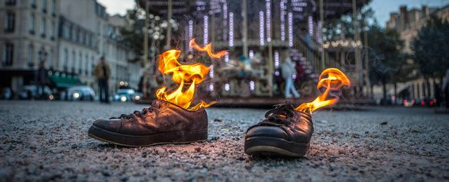 two shoes on fire on the ground outside