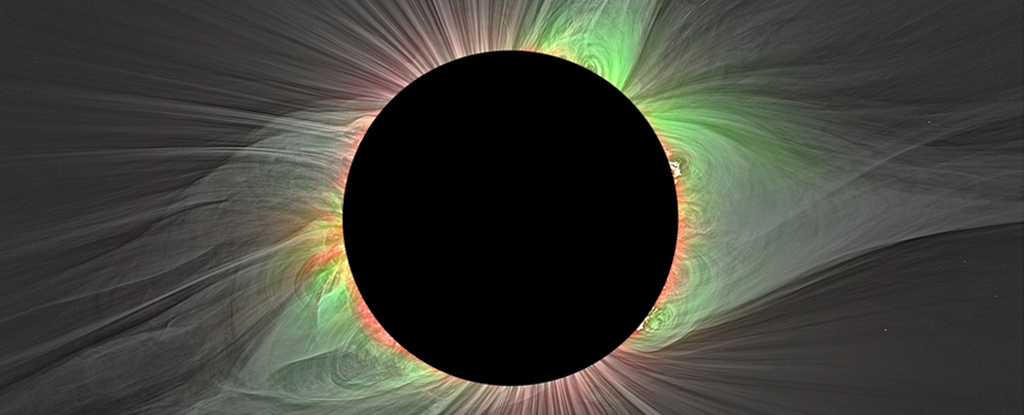 black circle where the sun is blocked, surrounded by coloured filaments of the solar wind