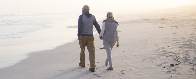 Elderly couple walking on a beach