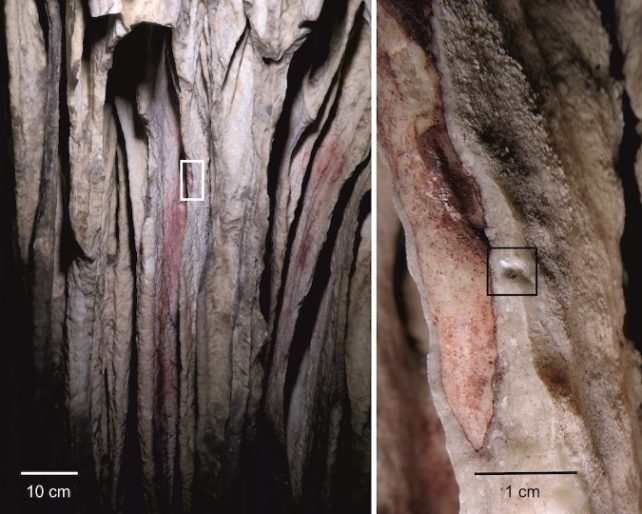 Red pigment washed into the concavities of a bright stalactite drapery in Ardales Cave