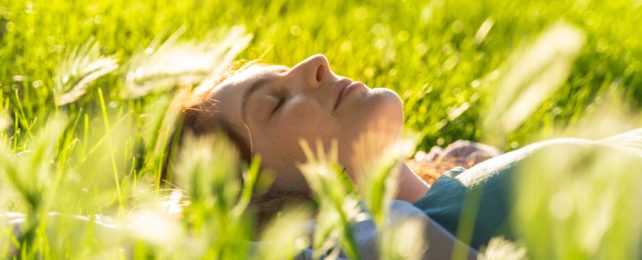 Woman Lies Serenely In Green Field