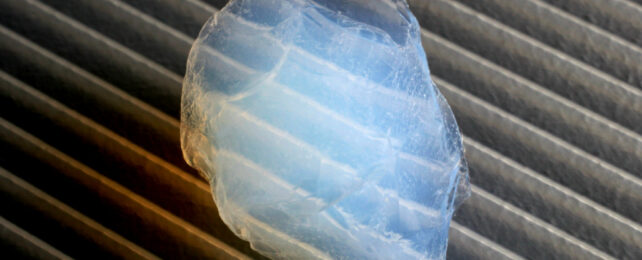 Blob of translucent aerogel sitting on corrugated surface.