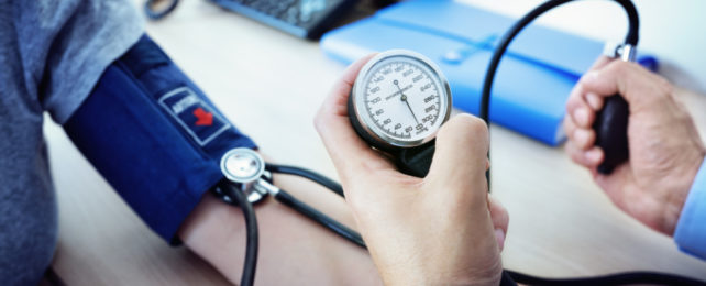 Doctor checking blood pressure