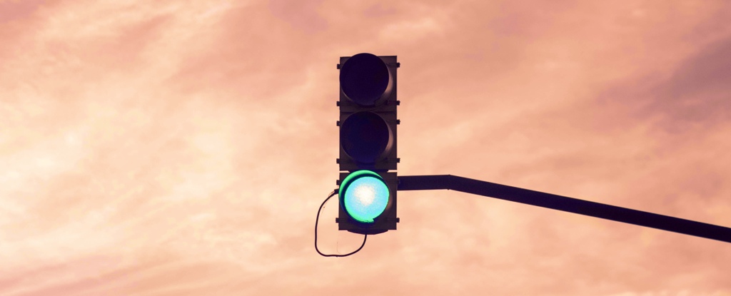 Traffic Light Shines Green Against Sky