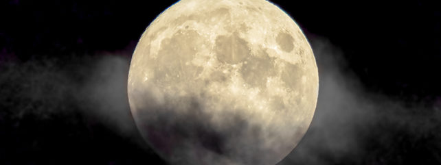 cloud passing over a full moon