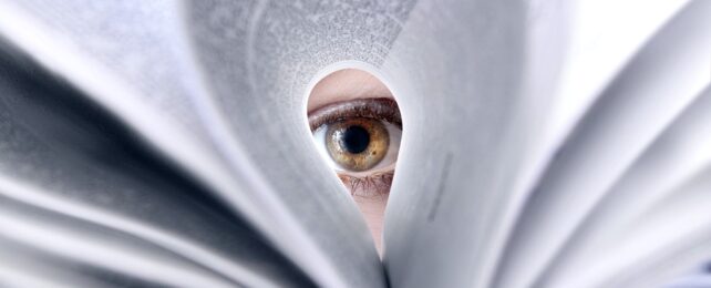 Eye Looking Through Book Page