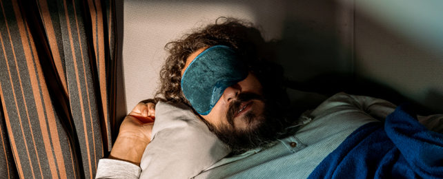 Person sleeping with an eye mask
