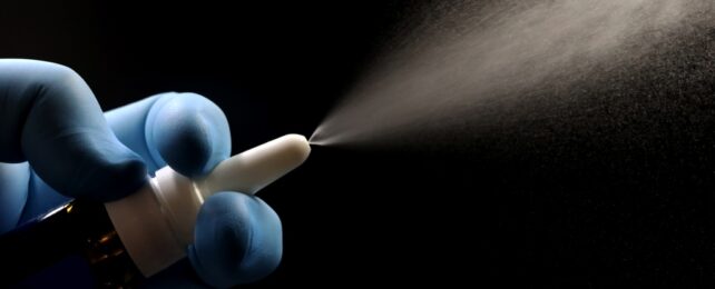 Gloved Hand Uses Nasal Spray
