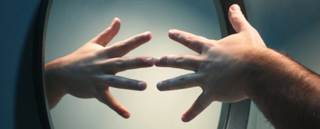 Hands Touching In Mirror