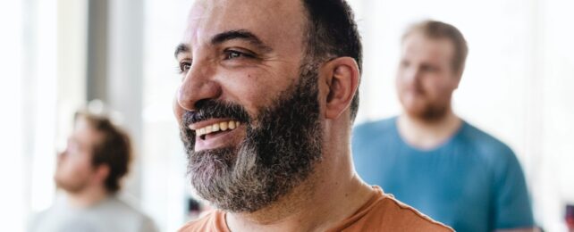 Man Smiles In Exercise Class