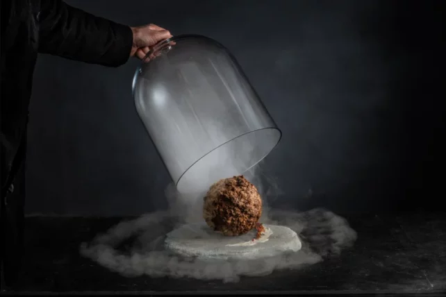 Meatball released from glass cover surrounded by steam