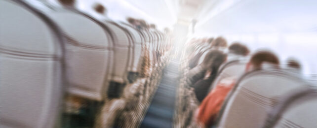 A shaky view of an airplane passenger aisle.