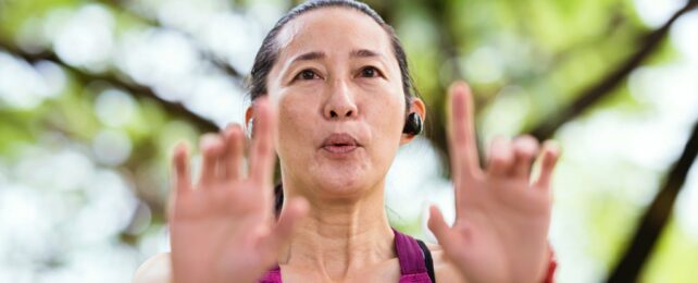 Woman Does Tai Chi In Park