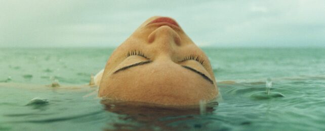 Woman lying in ocean