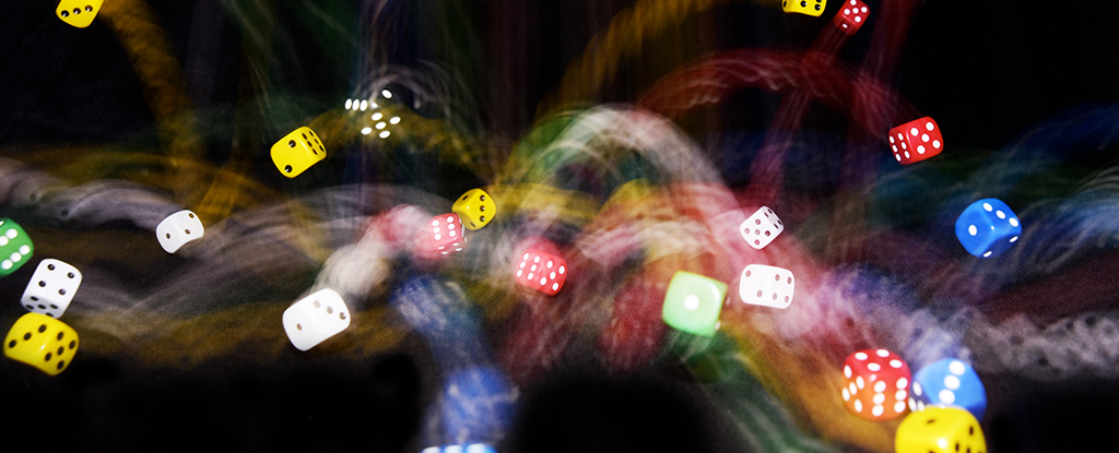 coloured dice in a blurred movement on a black background