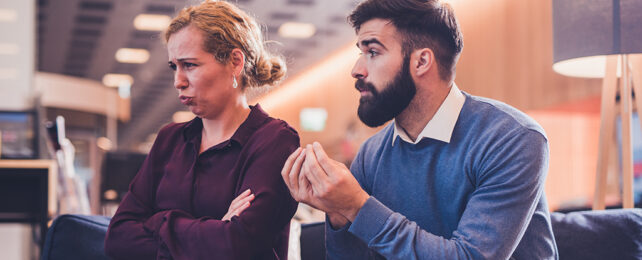 man and woman using facial expression and hands to communicate