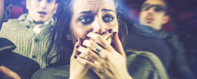 Woman with an expression of revulsion at the cinema