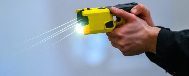 A police officer's hand demonstrating the handling of a Taser.