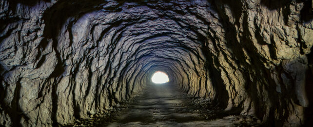 Distant light at the end of a cave tunnel