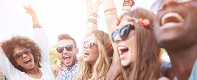 An image the faces of five happy smiling people wearing sunglasses