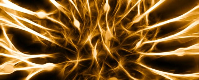 An abstract concept neural networks in yellow and brown with connections lighting up.