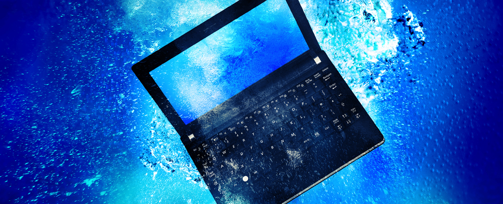 A laptop floating underwater.