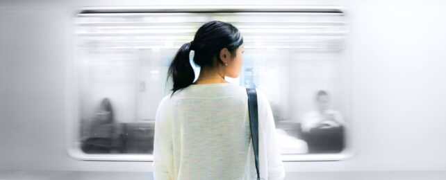 Woman Watches Train Pass