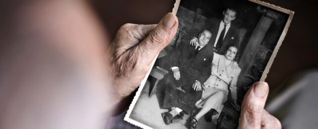 Old hands holding an old black and white photo