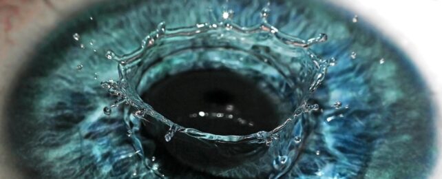 Close up of an eye with a drop splashing into it