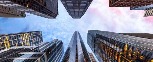 Looking up at blue sky above Chicago skyscrapers.