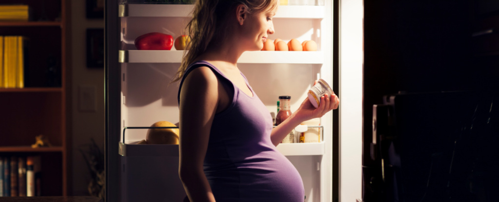 PregnantWomanStandingInFrontOfFridge