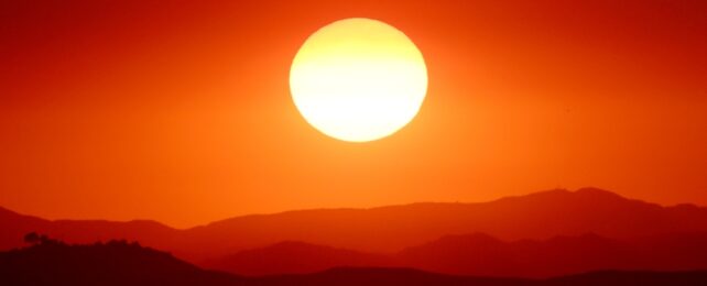Sun Sets Through Orange Haze