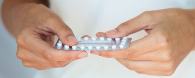 Woman Holds Pills In Hands