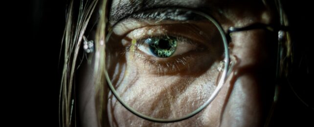 Young Man's Eye Behind Glasses