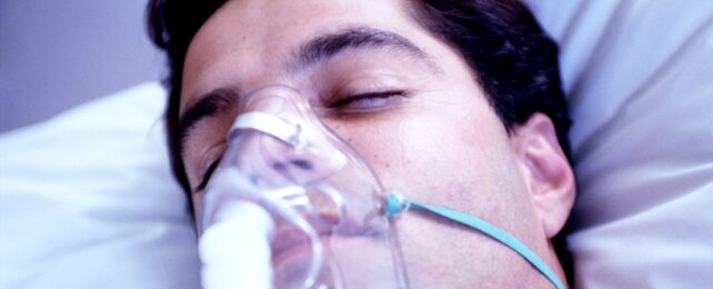 Male Patient In Hospital With Oxygen Mask