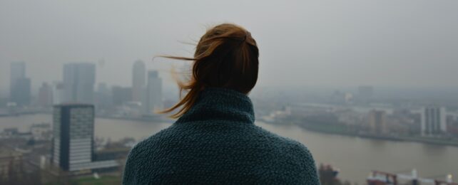 Woman Looks Over City