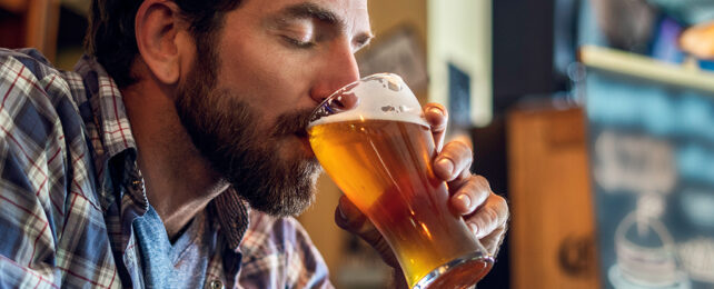 Man with beard drinking a beer