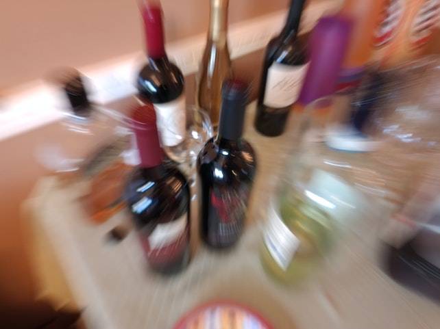 Blurry image of wine bottles on a table