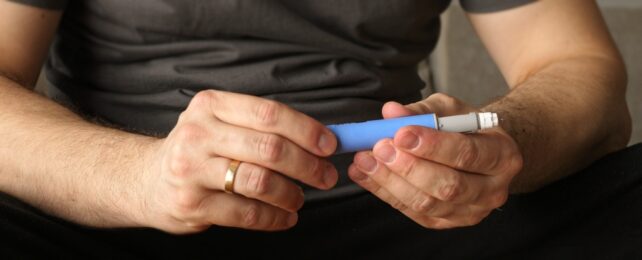 Man Holds Injector Device