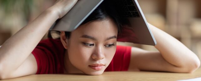 Student At Desk Looking Bored