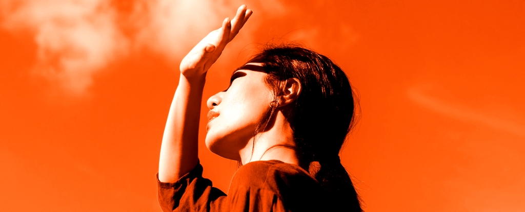 WomanShieldsEyesFromSun