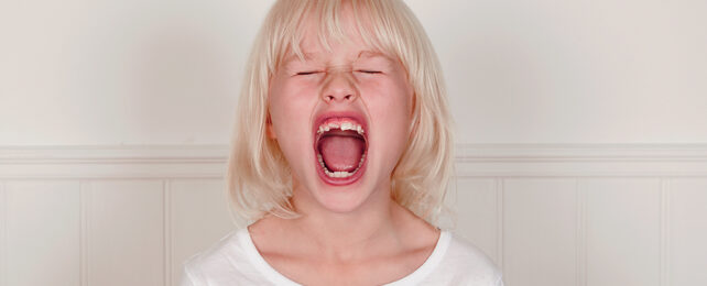 Small blonde girl with her mouth open